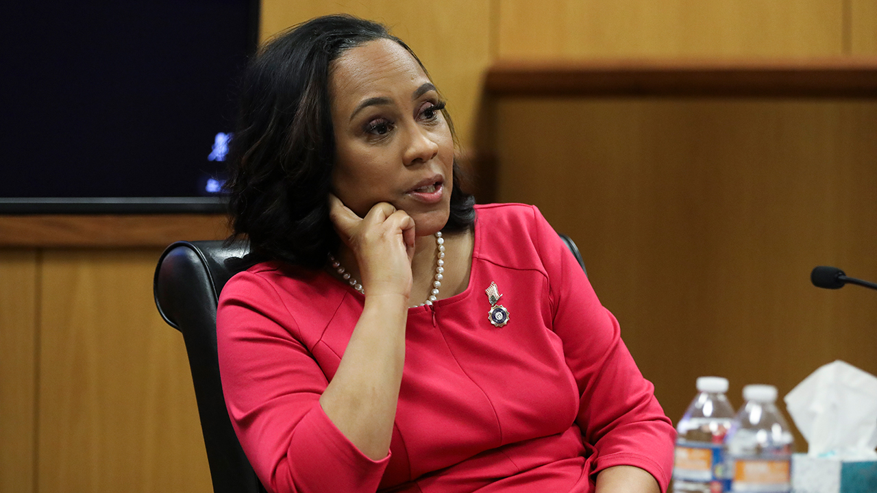 fani willis backwards pink dress Judge orders DA Fani Willis to step aside or cut ties with Nathan Wade